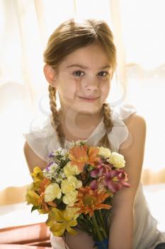 Royalty Free Photo of a Girl Holding a Bouquet of Flowers Smiling