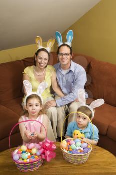 Royalty Free Photo of a Family Wearing Rabbit Ears With Easter Baskets Smiling