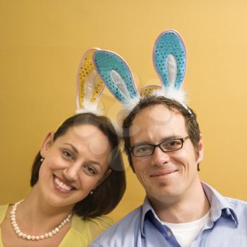 Royalty Free Photo of a Couple Wearing Rabbit Ears and Smiling