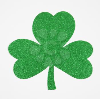 Royalty Free Photo of a Green Glitter Paper Shamrock on White