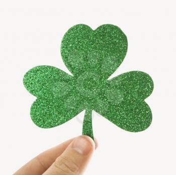 Royalty Free Photo of a Hand Holding a Green Glitter Paper Shamrock