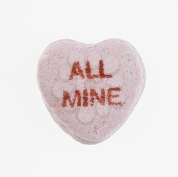 Royalty Free Photo of a Candy Heart That Reads All Mine Against a White Background
