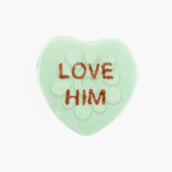Royalty Free Photo of a Green Candy Heart That Reads Love Him