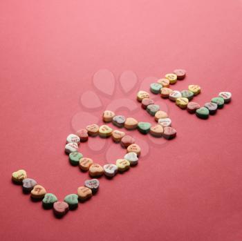 Royalty Free Photo of Colorful Candy Hearts With Sayings on Them Arranged to Spell the Word Love