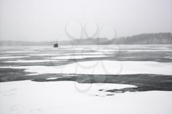 Royalty Free Photo of a Frozen Lake With an Ice Fishing Shack in Green Lake, Minnesota, USA