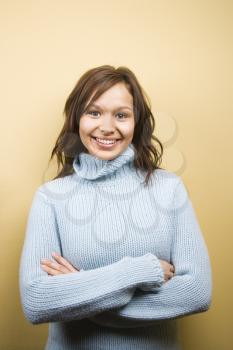 Royalty Free Photo of a Woman Standing With Her Arms Crossed and Smiling