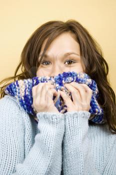 Royalty Free Photo of a Woman Covering Her Mouth With a Scarf