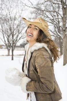 Royalty Free Photo of a Woman Standing and in the Snow Wearing a Straw Cowboy Hat