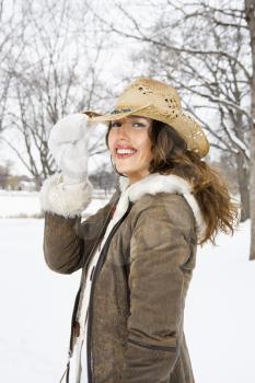 Royalty Free Photo of a Female Standing and in the Snow Wearing a Straw Cowboy Hat