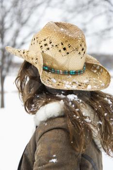 Royalty Free Photo of a Brunette Woman With Long Hair Wearing a Straw Cowboy Hat Outdoors