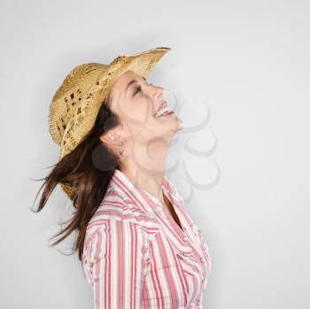 Royalty Free Photo of a Profile of a Woman Wearing a Cowboy Hat Smiling