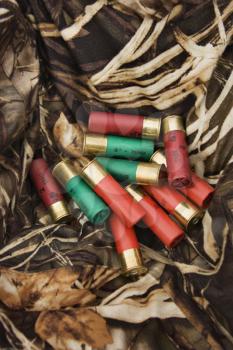 Royalty Free Photo of a Still Life Shot of Shotgun Shells Against Camouflage Clothing