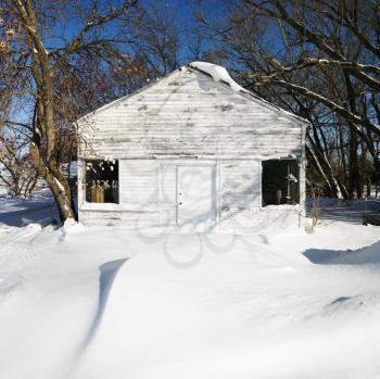 Royalty Free Photo of a White House Covered in Snow