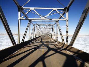 Royalty Free Photo of a Bridge With Unique Shadows Over Frozen Water in Midwestern, USA