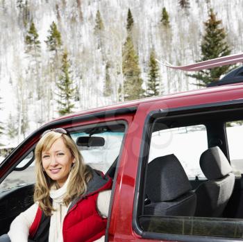 Royalty Free Photo of a Pretty Woman Sitting in a Car in Rural Snowy Colorado