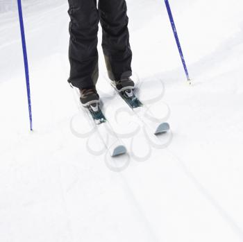 Royalty Free Photo of a Close-up of Skier Legs, Boots Poles and Skis Standing on s Slope