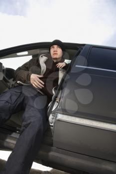 Royalty Free Photo of a Male Teenager Sitting in a Car