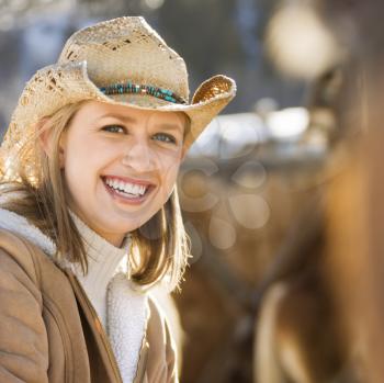 Royalty Free Photo of a Woman Wearing a Cowboy Hat Smiling
