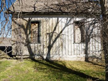Royalty Free Photo of an Old Rundown Building With a Tree and Shadows in Utah, USA