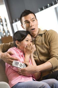 Royalty Free Photo of an Asian Female With a Scared Expression While an Asian Male Comforts Her
