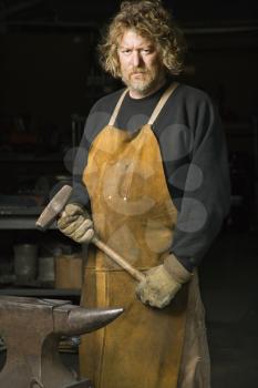 Royalty Free Photo of a Metal Smith in His Workshop
