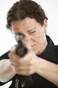Royalty Free Photo of a Female Law Enforcement Officer Aiming a Gun