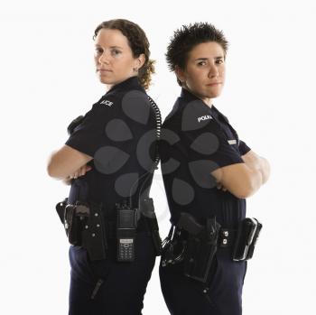 Royalty Free Photo of Policewomen Standing Back to Back With Their Arms Crossed