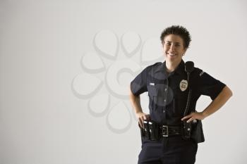 Royalty Free Photo of a Policewoman Standing with Hands on Gun Holster
