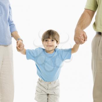 Royalty Free Photo of a Boy Holding Hands With His Parents 
