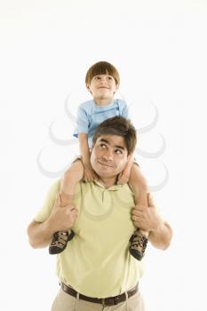 Royalty Free Photo of a Father Holding His Son on His Shoulders