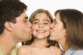 Royalty Free Photo of a Mother and Father Kissing Their Daughter on the Cheeks