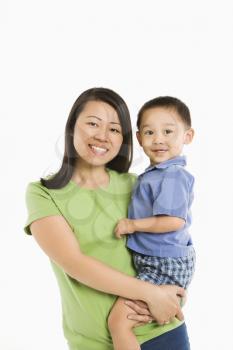 Royalty Free Photo of a Mother Holding Her Son on Her Hip Smiling