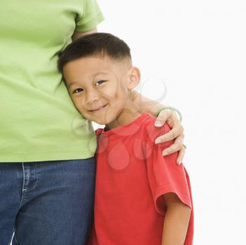 Royalty Free Photo of a Mother Standing With Her Arm Around Her Son