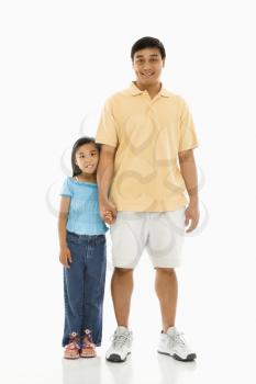 Royalty Free Photo of a Father Standing Holding Hands With His Daughter