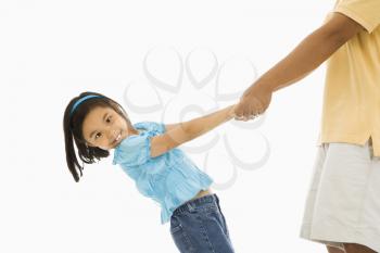 Asian girl holding father's hands and leaning back.