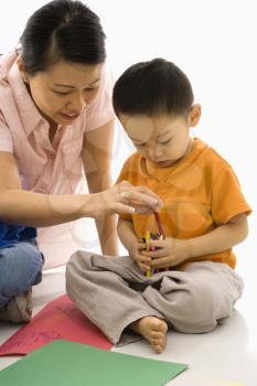 Royalty Free Photo of a Mother and Son Sitting Coloring 