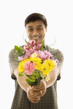 Royalty Free Photo of a Man Holding Out a Bouquet of Flowers and Smiling