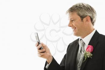 Royalty Free Photo of a Groom Using His Cellphone