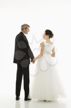 Royalty Free Photo of a Groom and Bride Holding Hands