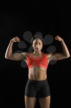 Royalty Free Photo of a Muscular Woman Wearing Athletic Apparel With Biceps Flexed