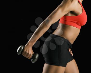Royalty Free Photo of the Torso of a Woman Lifting a Dumbbell