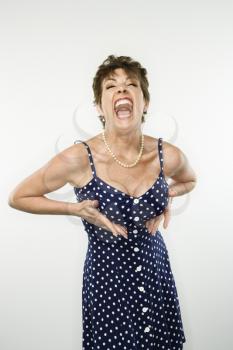 Royalty Free Photo of a Woman in a Polka Dot Dress Accentuating Her Breasts