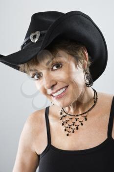 Royalty Free Photo of a Woman Smiling and Wearing a Cowboy Hat
