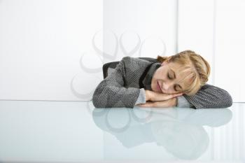Royalty Free Photo of a Woman Sleeping on a Desk