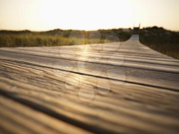 Royalty Free Photo of Low Angle View of a Wooden Boardwalk Leading to a Beach at Bald Head Island, North Carolina