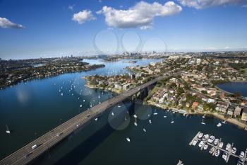 Royalty Free Photo of an Aerial View of Victoria Road Bridge and Boats With Distant Downtown Skyline in Sydney, Australia