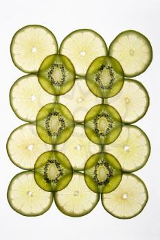 Royalty Free Photo of Lime and Kiwi Fruit Slices Arranged on a White Background