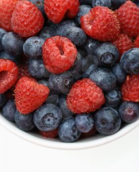 Royalty Free Photo of a Bowl of Mixed Blueberries and Raspberries
