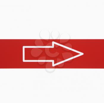 Royalty Free Photo of a Red Sign With an Arrow Against White Background
