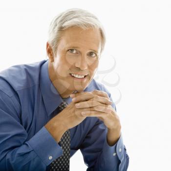 Royalty Free Photo of a Man With Hands Folded Smiling